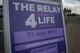 A sign displays the Relay for Life event information next to the outdoor track at Spangdahlem Air Base, Germany, July 31, 2015. The event raised more than $23,000 in support funding cancer research development and improving quality of life for patients by providing lodging facilities, transportation and support programs. (U.S. Air Force photo by Airman 1st Class Luke Kitterman/Released) 