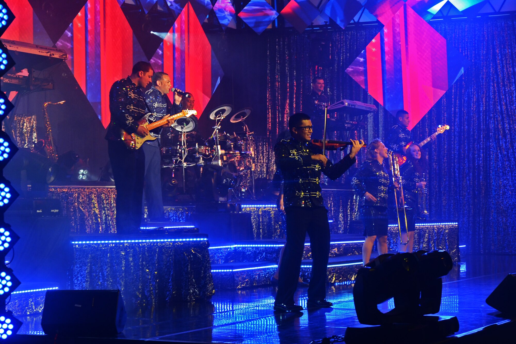 Tops in Blue Airmen perform at the Coral Reef Fitness Center Aug. 1, 2015, at Andersen Air Force Base, Guam. More than 700 people attended the show which had a set list of many current popular songs and a hit song from each decade spanning from 1910 to 1990. (U.S. Air Force photo by Airman 1st Class Alexa Ann Henderson/Released)