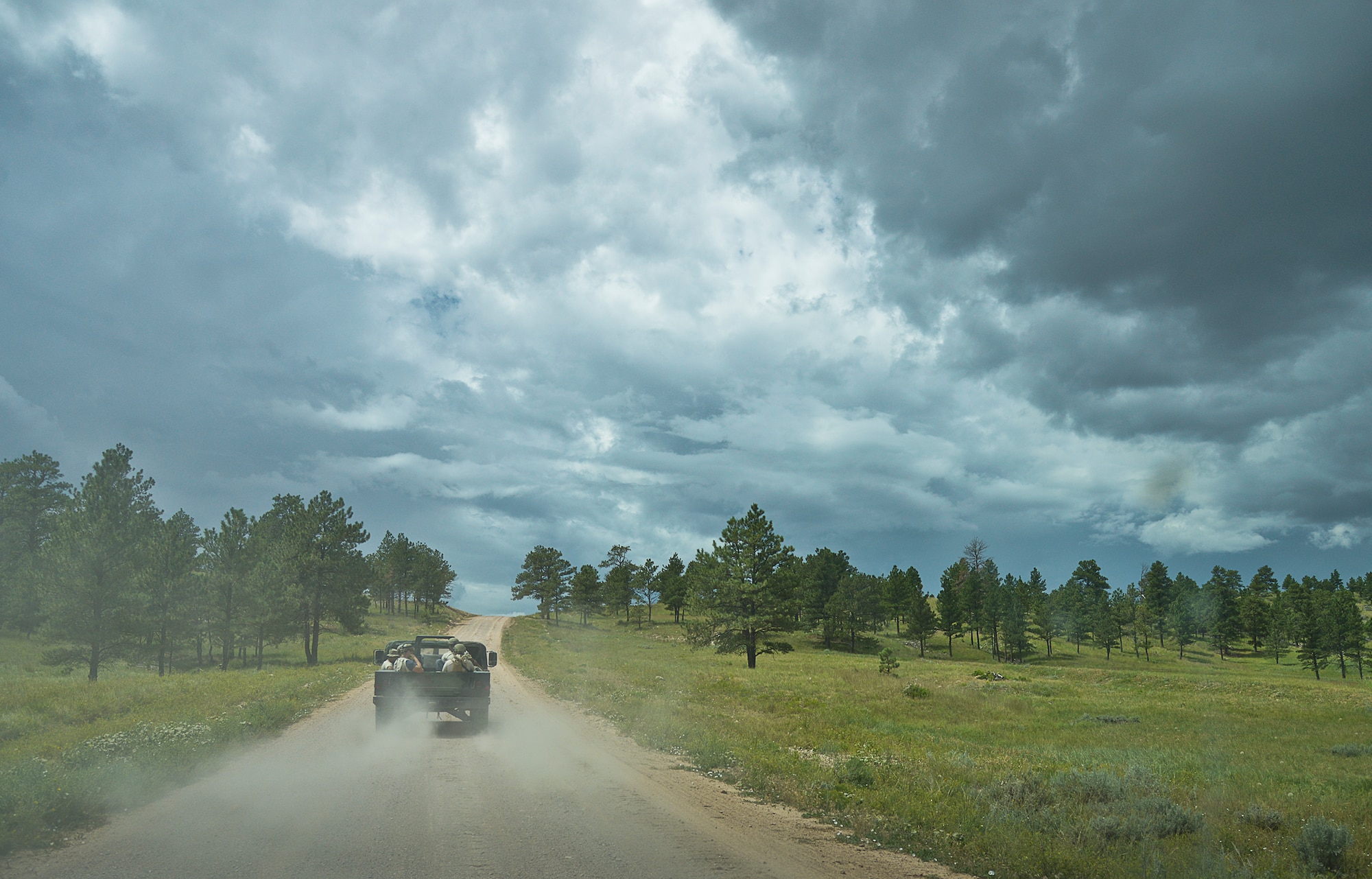 919th Special Operations Security Forces Squadron Airmen move toward their base of operations in the back of a Humvee prior to a rain storm at Camp Guernsey, Wyo., Aug. 4.  More than 20 Airmen went out West to help train two other Reserve security forces squadrons in ground combat and field training.  The 919th SOSFS Airmen lived in the makeshift camps and acted as opposing forces and local villagers interacting with the occupying security teams. (U.S. Air Force photo/Tech. Sgt. Sam King)