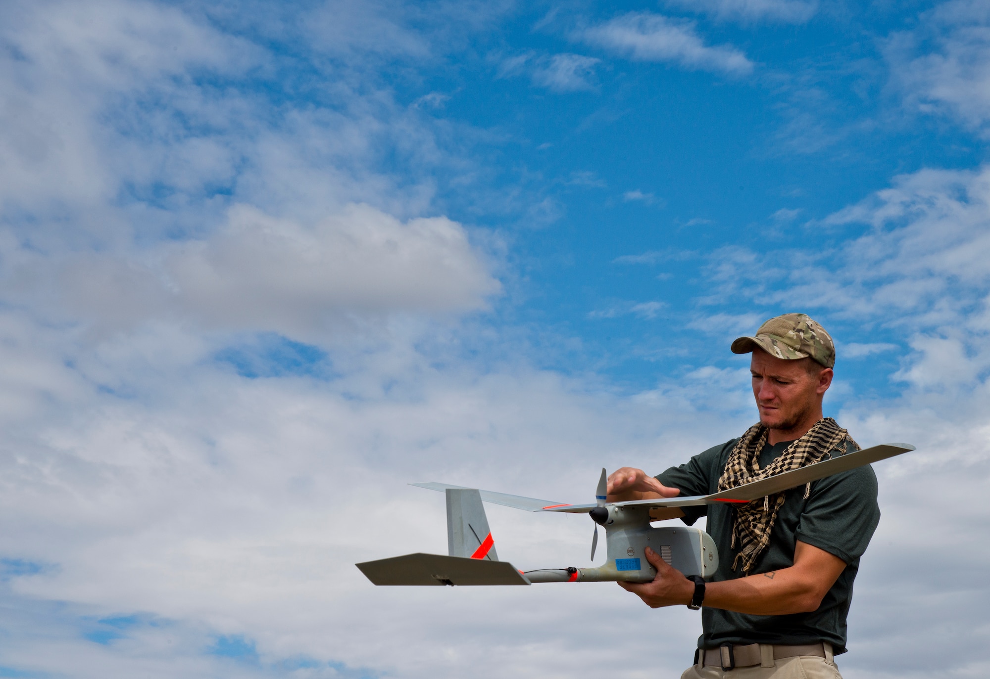 Staff Sgt. Leland Hastings, 919th Special Operations Security Forces Squadron, prepares to launch the Raven-B, a four-by-four foot unmanned aerial system, into the skies above Camp Guernsey, Wyo., Aug. 4.  The 919th SOSFS brought the UAS to demonstrate its capabilities to other security forces units involved in a large field training exercise at the camp. The Raven-B has the ability to take photos, video in day or night, and even designate locations via an IR laser.  It also provides coordinates, magnetic azimuths, and linear distances creating a birds-eye view to topographical map. (U.S. Air Force photo/Tech. Sgt. Sam King)
