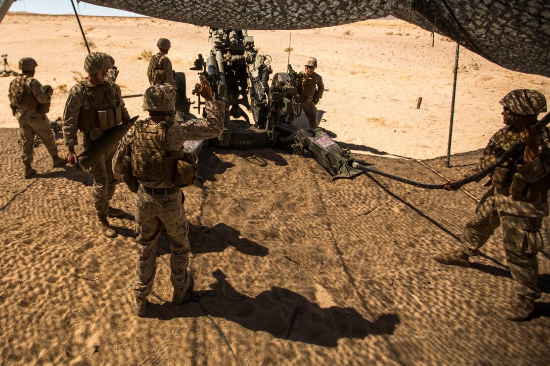U.S. Marine Corps Cpl. Tyler Sansonetti, gun chief with Battery C, 1st Battalion, 10th Marine Regiment, gives the command to fire as part of reinforcing ground combat element units in fire support coordination drills during an Integrated Training Exercise (ITX) aboard Marine Corps Air Ground Combat Center Twentynine Palms, Calif., July 27, 2015. ITX is conducted to enhance the integration and warfighting capability from all elements of the Marine Air Ground Task Force. (U.S. Marine Corps photo by Lance Cpl. Clarence A. Leake/Released)