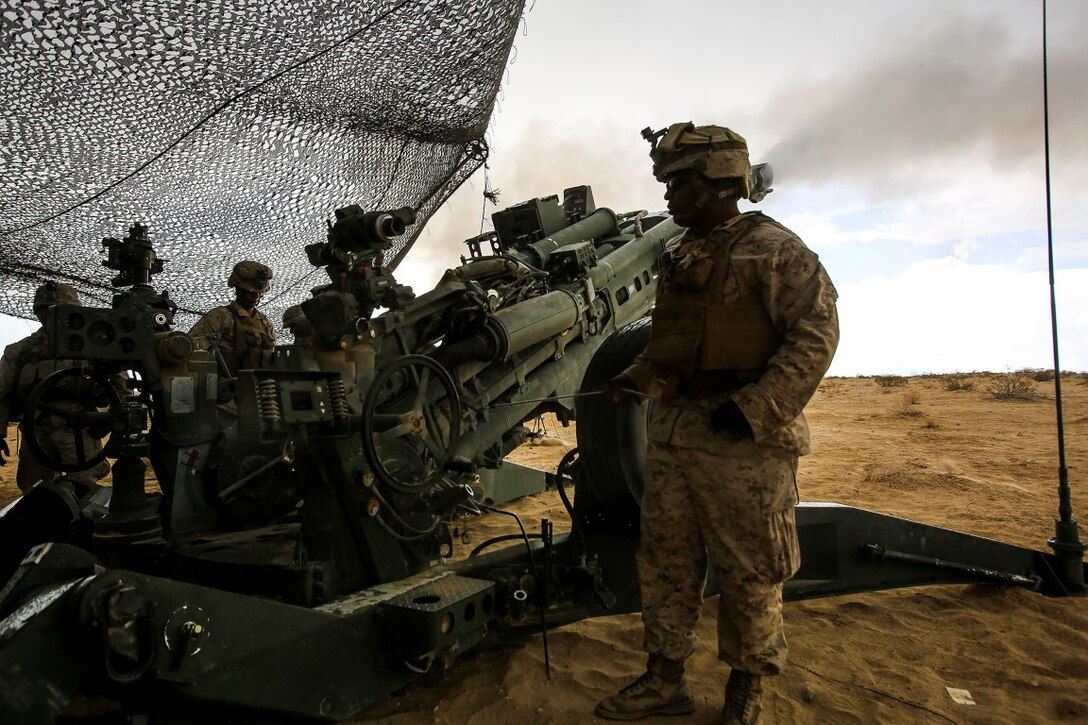 Marines with Battery B, 1st Battalion, 10th Marine Regiment, participate in a fire support coordination exercise with ground combat element units aboard Marine Corps Air Ground Combat Center Twentynine Palms, California, July 29, 2015. The training event took place during an Integrated Training Exercise, which is conducted to enhance the integration and warfighting capability from all elements of the Marine Air Ground Task Force. 1/10 Marines provided fire support through artillery assets while enhancing communication efforts within the battery. (U.S. Marine Corps Photo by Cpl. Rick Hurtado / Released)