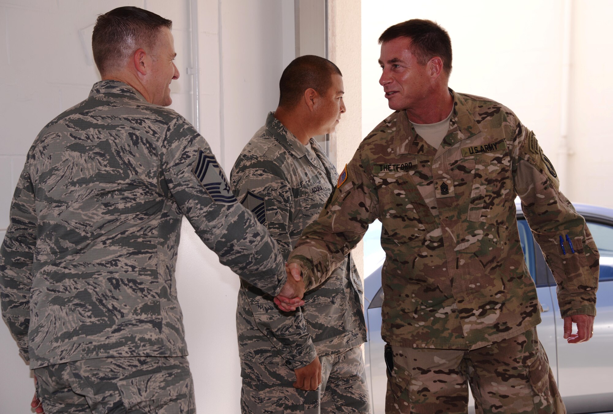 From left, Chief Master Sgt. Scott Smith, 353rd Special Operations Maintenance Squadron superintendent, greets Command Sgt. Maj. William Thetford, U.S. Special Operations Command senior enlisted leader, during a visit July 29, 2015 at Kadena Air Base, Japan.  During his visit to the 353rd Special Operations Group, Thetford visited with the Airmen as they provided displays to show Thetford first-hand what the Special Operations Airmen do in the Indo-Asia Pacific region.  (U.S. Air Force photo by Tech. Sgt. Kristine Dreyer)