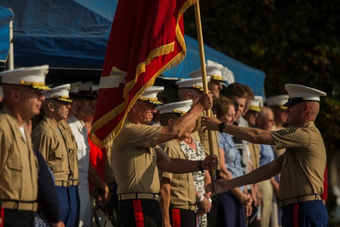 U.S. Marine Corps Sgt. Maj. William T. Sowers, 1st Marine Division Sergeant Major, presents the battle colors to Maj. Gen. Lawrence D. Nicholson, 1st Marine Division Commanding General, during a change of command ceremony at Marine Corps Base Camp Pendleton, Calif., July 30, 2015. The ceremony signifies the transfer of responsibility and authority of 1st Marine Division between Commanding Generals. (U.S. Marine Corps photo by Lance Cpl. Ryan Kierkegaard/Released)