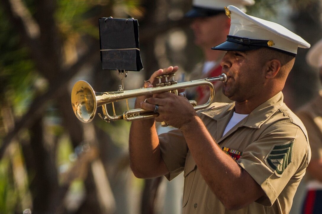 U.S. Marines Corps Staff Sgt. Steven Santiago-Ramos, a trumpet player with the 1st Marine Division Band, performs during a change of command ceremony at Marine Corps Base Camp Pendleton, Calif., July 30, 2015. The ceremony signifies the transfer of responsibility and authority of 1st Marine Division between Commanding Generals. (U.S. Marine Corps photo by Lance Cpl. Ryan Kierkegaard/Released)