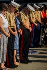 U.S. Marines and their guests stand for the invocation during a change of command ceremony at Marine Corps Base Camp Pendleton, Calif., July 30, 2015. The ceremony signifies the transfer of responsibility and authority of 1st Marine Division between Commanding Generals. (U.S. Marine Corps photo by Lance Cpl. Ryan Kierkegaard/Released)