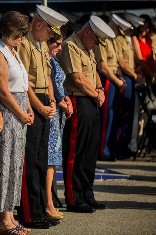U.S. Marines and their guests stand for the invocation during a change of command ceremony at Marine Corps Base Camp Pendleton, Calif., July 30, 2015. The ceremony signifies the transfer of responsibility and authority of 1st Marine Division between Commanding Generals. (U.S. Marine Corps photo by Lance Cpl. Ryan Kierkegaard/Released)