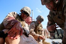U.S. Navy corpsmen and Marines, assigned to various units in the 1st Marine Division, conduct tactical combat casualty care training during the Combat Trauma Management Course, taught by instructors with the 1st Mar. Div. Navy Education and Training Office, at the Strategic Operations facility, San Diego, July 30, 2015. The course, held once a month for 40 students, combines simulated injuries on role players and chaotic battlefield environments to prepare corpsmen and Marine combat life savers for the stress of saving lives in real world operations.   (U.S. Marine Corps photo by Staff Sgt. Bobbie A. Curtis)