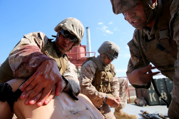 U.S. Navy corpsmen and Marines, assigned to various units in the 1st Marine Division, conduct tactical combat casualty care training during the Combat Trauma Management Course, taught by instructors with the 1st Mar. Div. Navy Education and Training Office, at the Strategic Operations facility, San Diego, July 30, 2015. The course, held once a month for 40 students, combines simulated injuries on role players and chaotic battlefield environments to prepare corpsmen and Marine combat life savers for the stress of saving lives in real world operations.   (U.S. Marine Corps photo by Staff Sgt. Bobbie A. Curtis)