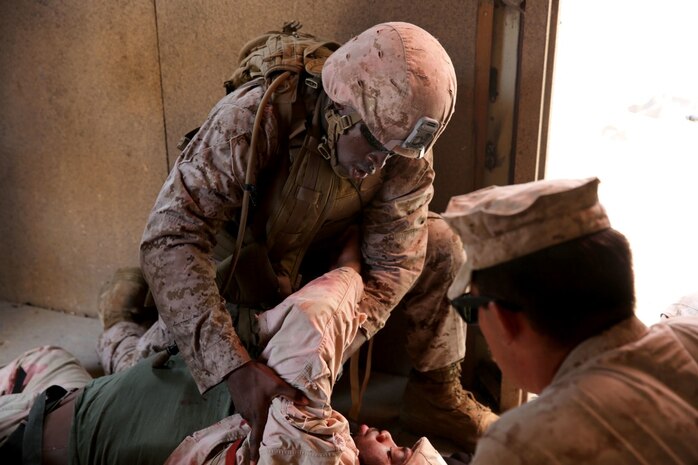 U.S. Navy corpsmen and Marines, assigned to various units in the 1st Marine Division, conduct tactical combat casualty care training during the Combat Trauma Management Course, taught by instructors with the 1st Mar. Div. Navy Education and Training Office, at the Strategic Operations facility, San Diego, July 30, 2015. The course, held once a month for 40 students, combines simulated injuries on role players and chaotic battlefield environments to prepare corpsmen and Marine combat life savers for the stress of saving lives in real world operations.   (U.S. Marine Corps photo by Staff Sgt. Bobbie A. Curtis)