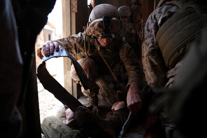 A U.S. Navy corpsman, assigned to the 1st Marine Division, conducts tactical combat casualty care training during the Combat Trauma Management Course, taught by instructors from the 1st Mar. Div. Navy Education and Training Office, at the Strategic Operations facility, San Diego, July 30, 2015. The course, held once a month for 40 students, combines simulated injuries on role players and chaotic battlefield environments to prepare corpsmen and Marine combat life savers for the stress of saving lives in a real world operations.   (U.S. Marine Corps photo by Staff Sgt. Bobbie A. Curtis)