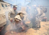 U.S. Navy corpsmen and Marines, assigned to various units in the 1st Marine Division, conduct tactical combat casualty care training during the Combat Trauma Management Course, taught by instructors with the 1st Mar. Div. Navy Education and Training Office, at the Strategic Operations facility, San Diego, July 30, 2015. The course, held once a month for 40 students, combines simulated injuries on role players and chaotic battlefield environments to prepare corpsmen and Marine combat life savers for the stress of saving lives in real world operations.   (U.S. Marine Corps photo by Staff Sgt. Bobbie A. Curtis)