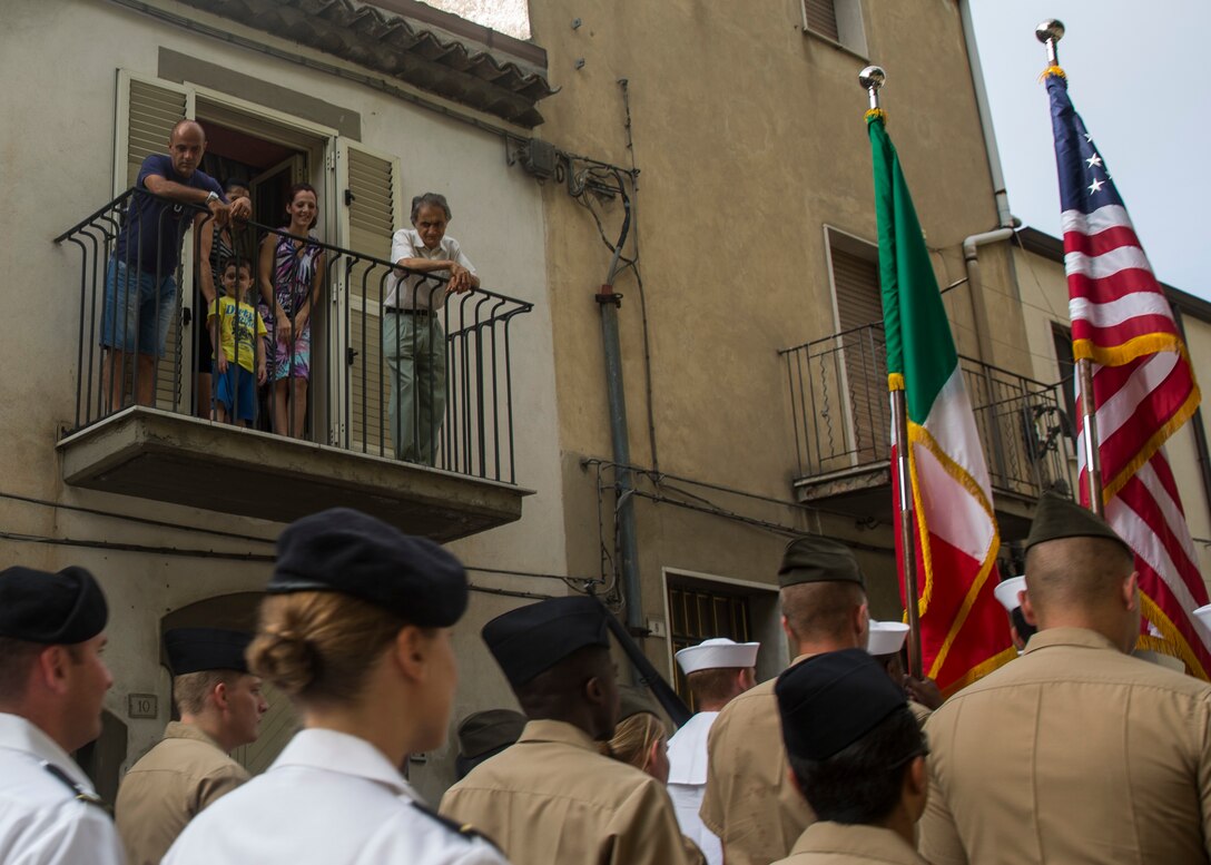 Residents of Troina, Sicily, Italy, overlook the Marines and sailors with Special-Purpose Marine Air-Ground Task Force Crisis Response-Africa, Detachment A, as they parade through the streets alongside Italian veterans during the Battle of Troina remembrance ceremony August 2, 2015. Representatives of the Sicilian community, civil and military, participated side-by-side with their American counterparts honored the sacrifices made during the battle in 1943. (U.S. Marine Corps photo by Cpl. Olivia McDonald/Released)