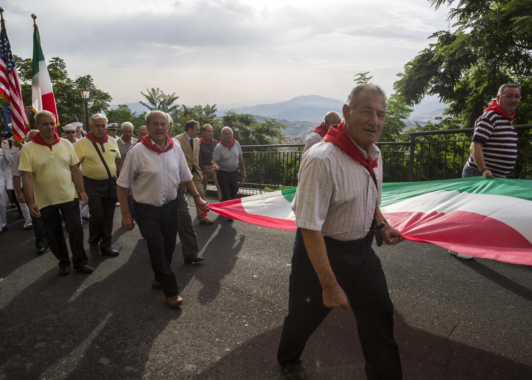 Italian military veterans of Troina, Sicily, Italy, lead Marines and sailors with Special-Purpose Marine Air-Ground Task Force Crisis Response-Africa, Detachment A, in a parade as part of the Battle of Troina Ceremony August 2, 2015. The Marines and sailors also observed a mass and participated in a wreath laying ceremony in honor of the lives lost in the Battle of Troina in World War II. (U.S. Marine Corps photo by Cpl. Olivia McDonald/Released)