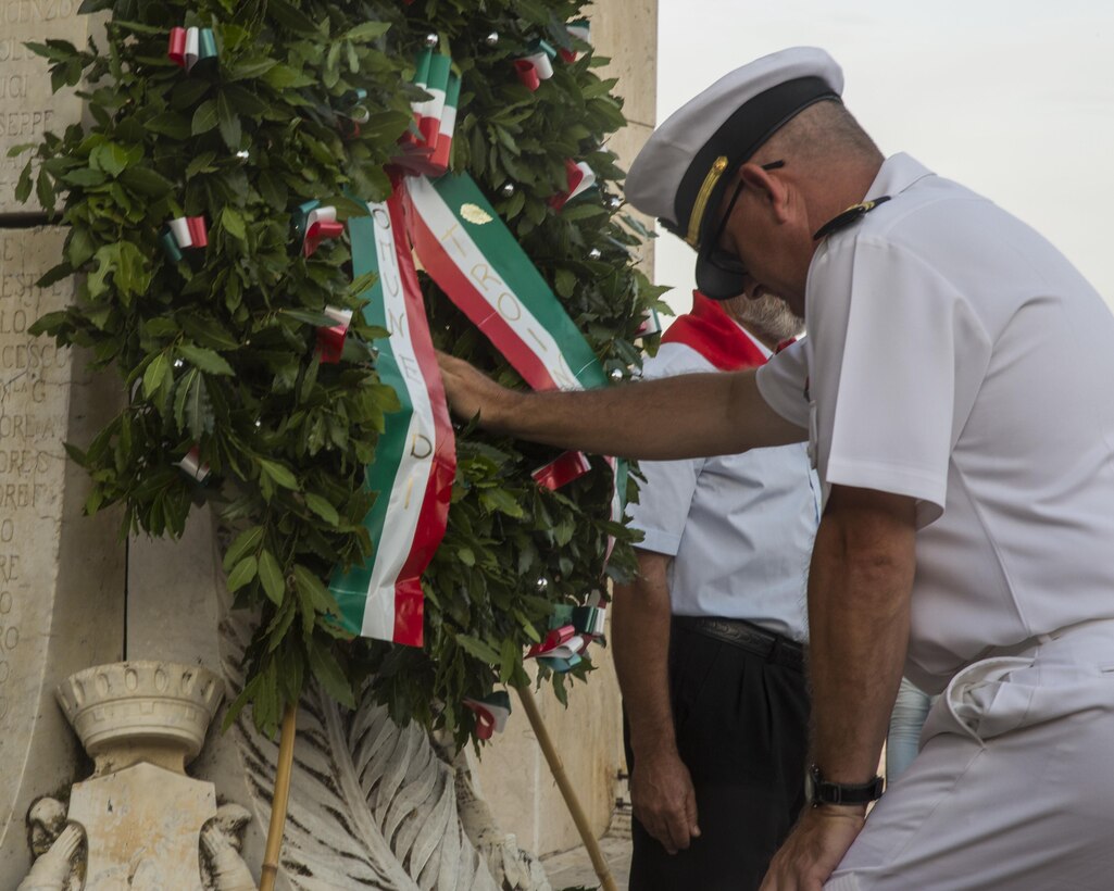 Navy Lt. Derrick Horne, the chaplain with Special-Purpose Marine Air-Ground Task Force Crisis Response-Africa, Detachment A, pays respect for the sacrifices made during the Battle of Troina in World War II during a wreath-laying ceremony in Troina, Sicily, Italy, August 2, 2015. Horne later offered a prayer in honor of the civilian and military casualties during that battle in 1943. (U.S. Marine Corps photo by Cpl. Olivia McDonald/Released)