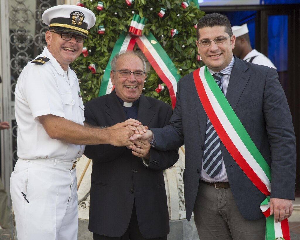 Navy Lt. Derrick Horne, (left) chaplain with the Special-Purpose Marine Air-Ground Task Force Crisis Response-Africa, Detachment A, shakes the hands of the Tronia cathedral’s preist and Fabio Venezia, the town’s mayor, during a wreath-laying ceremony in Troina, Sicily, Italy during the Battle of Troina, World War II remembrance ceremony, August 2, 2015. For the first time since 1959, representatives from the U.S. military participated in Troina’s commemoration of the loss and sacrifice of the Battle of Troina in 1943. (U.S. Marine Corps photo by Cpl. Olivia McDonald/Released)