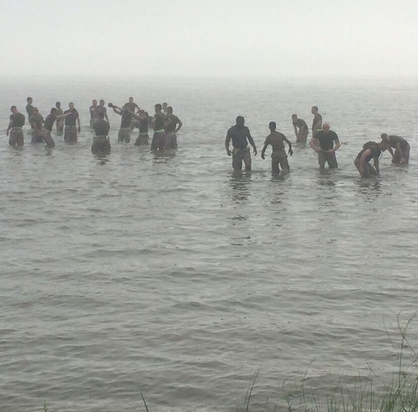 29 Jul 2015 – Weapons Training Battalion Marines, sailors, and civilians conduct battalion physical training in the morning fog on Stones Bay, Camp Lejeune.  Teams pushed  all-terrain vehicles to various stations to conduct exercises, including kettlebell swings and a short running course in the bay.  The event culminated with a single-elimination volleyball-like tournament using medicine balls and a hail & farewell fish-fry.
