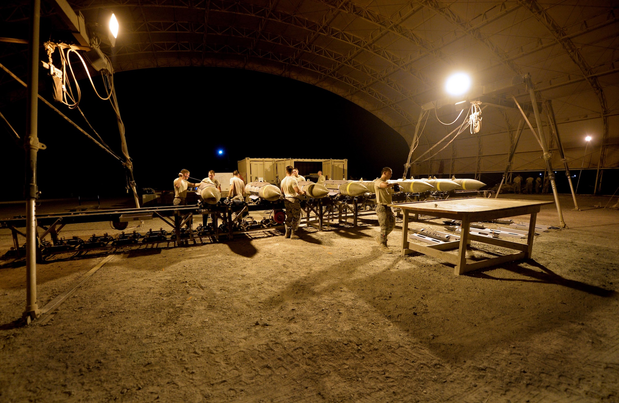 Expeditionary Maintenance Squadron conventional maintenance crewmembers assemble a Guided Bomb Unit 31 version 3’s at an undisclosed location in Southwest Asia July 30, 2015. The ammo team here utilizes a munitions assembly conveyor, or MAC, to streamline the assembly of munitions. (U.S. Air Force photo/Tech. Sgt. Jeff Andrejcik)