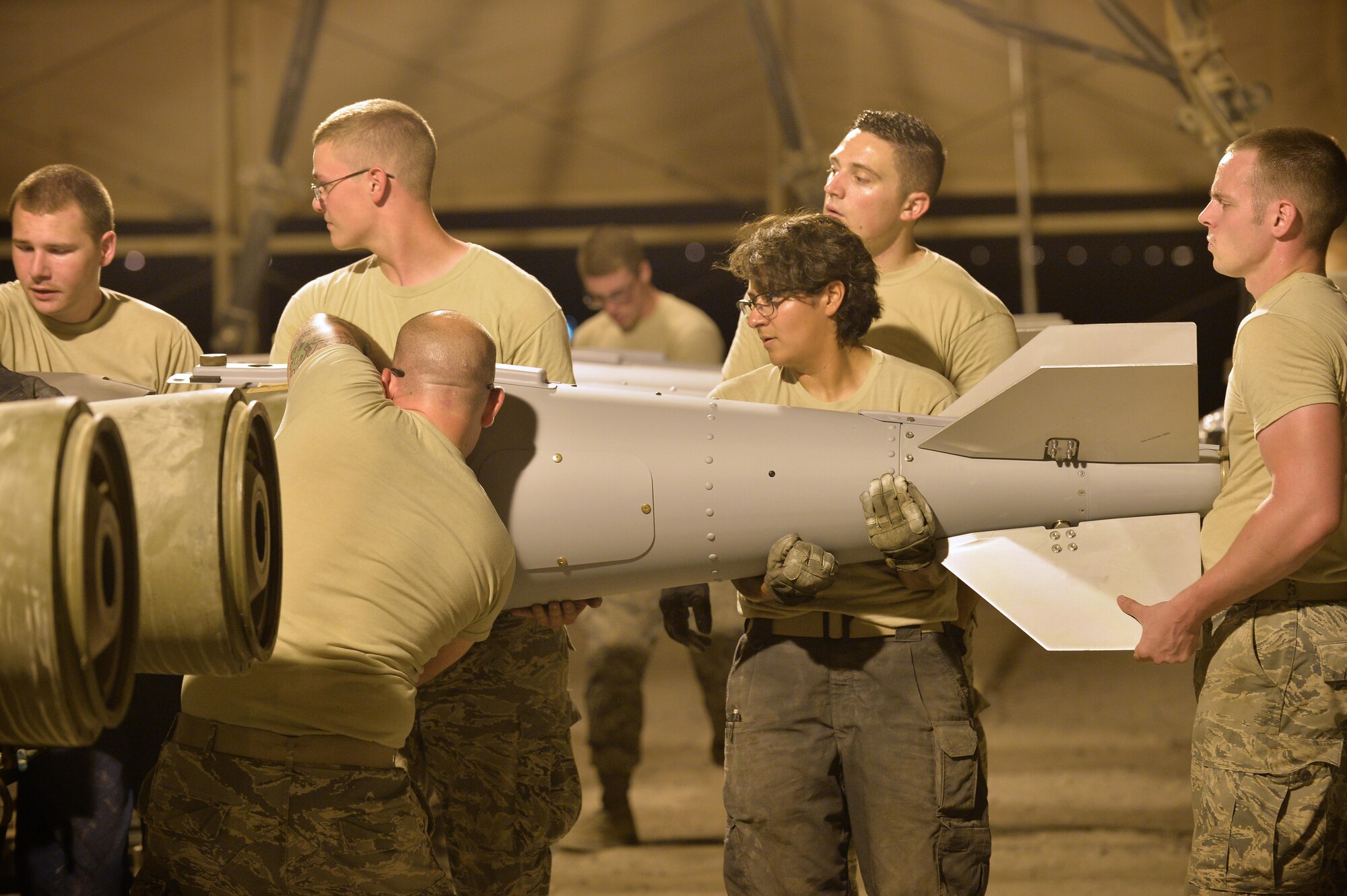 Expeditionary Maintenance Squadron conventional maintenance crewmembers assemble a Guided Bomb Unit 31 version 3 at an undisclosed location in Southwest Asia July 30, 2015. The munitions produced here have been utilized to support OPERATION INHERENT RESOLVE and FREEDOM SENTINEL, multi-national efforts to eliminate the Islamic State in Iraq and the Levant, or ISIL. (U.S. Air Force photo/Tech. Sgt. Jeff Andrejcik)
