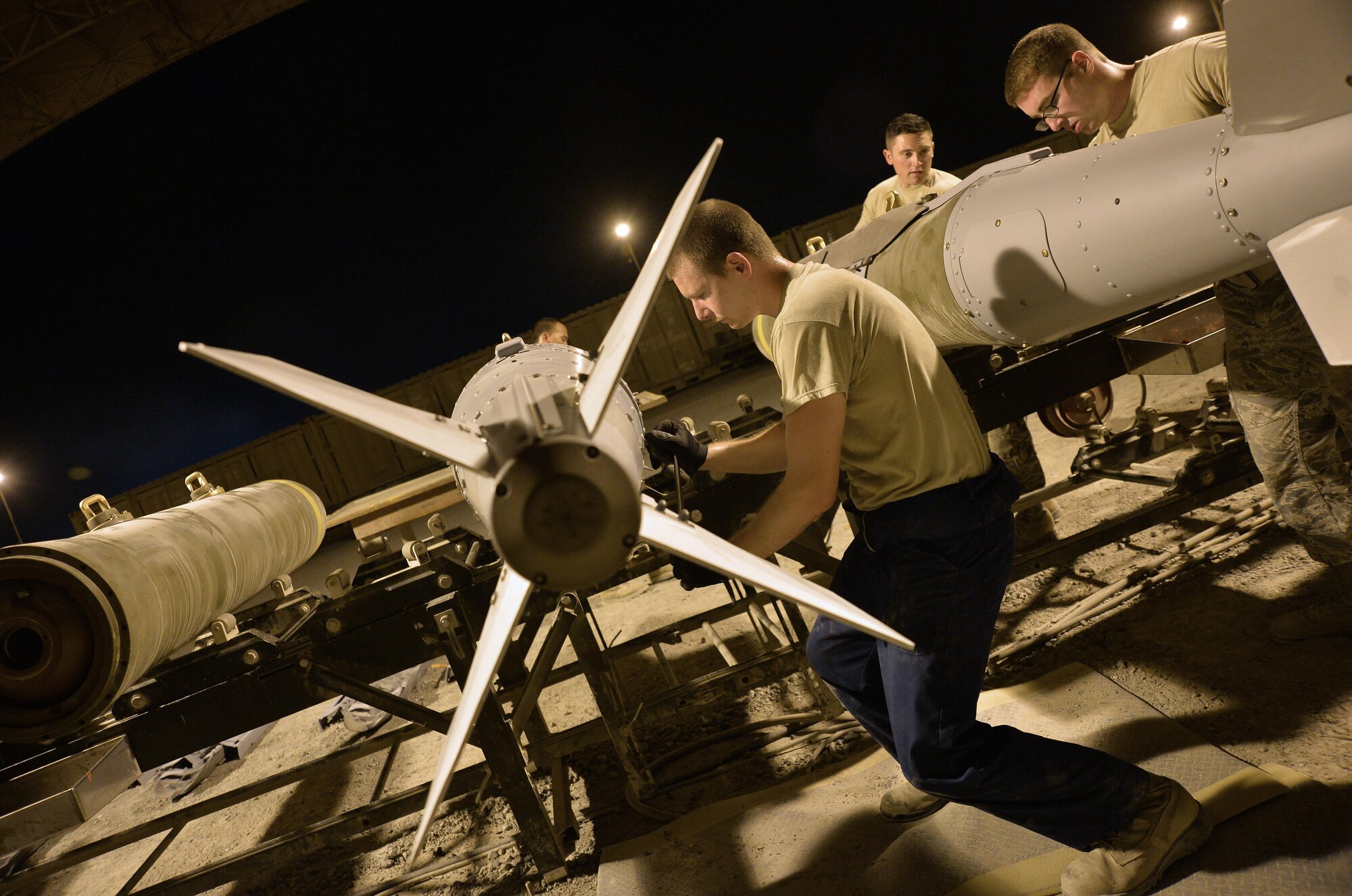 Senior Airman Jeremiah, Expeditionary Maintenance Squadron conventional maintenance crewmember, secures the bolts on a Guided Bomb Unit 31 version 3 at an undisclosed location in Southwest Asia July 30, 2015. The GBU-31 is a hardened target penetrator bomb manufactured here to meet the objectives of OPERATION INHERENT RESOLVE and FREEDOM SENTINEL, multi-national efforts to eliminate the Islamic State in Iraq and the Levant, or ISIL. (U.S. Air Force photo/Tech. Sgt. Jeff Andrejcik)