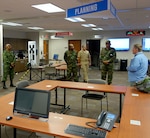 Members of Suriname’s Defense discuss emergency
operations with an official from the Pennington County emergency management office in Rapid City, S.D., July 28, 2015. The Surinamese service members were in South Dakota on a subject matter expert exchange focusing on emergency operations through the National Guard Bureau’s State Partnership Program. 