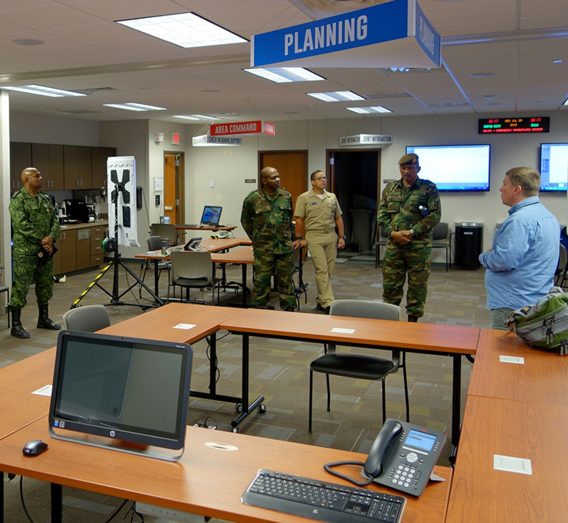 Members of Suriname’s Defense discuss emergency
operations with an official from the Pennington County emergency management office in Rapid City, S.D., July 28, 2015. The Surinamese service members were in South Dakota on a subject matter expert exchange focusing on emergency operations through the National Guard Bureau’s State Partnership Program. 