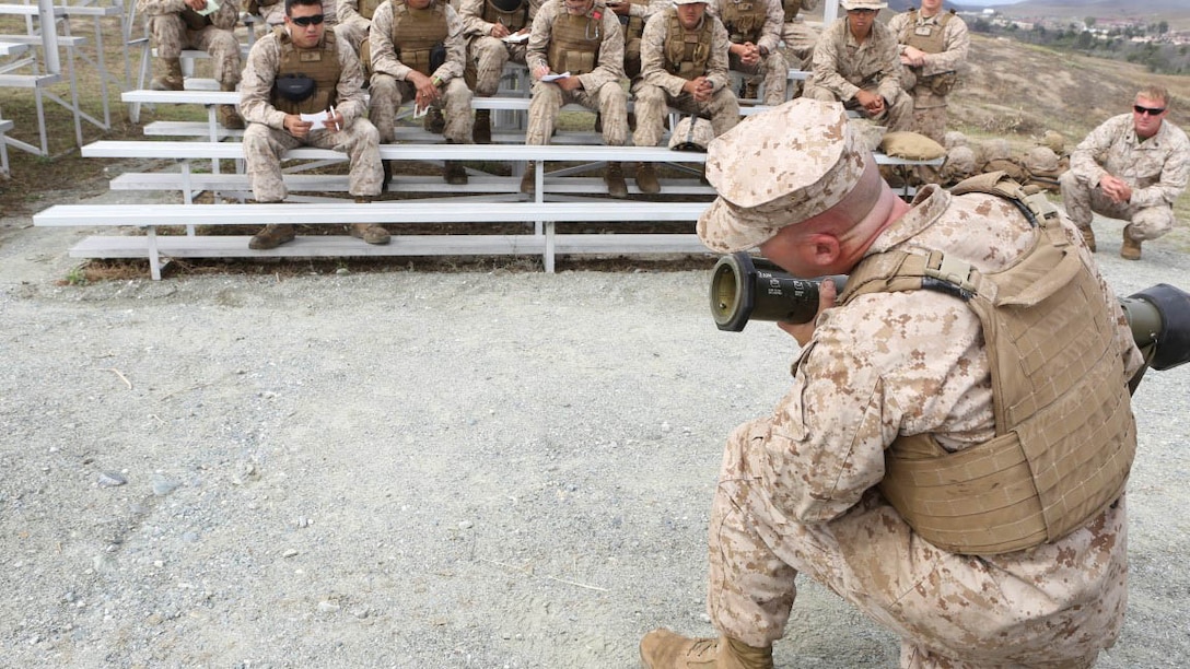 Gunnery Sgt. David C. Stone, a maintenance chief with Company D, 4th Tank Battalion, 4th Marine Division, explains proper handling of the AT-4 to Marines with Company D, 4th Tank Bn. during a battalion-level Fire Support Coordination Exercise aboard Marine Corps Base Camp Pendleton, Calif., July 14- 24 for fiscal year 2015. Training included live fire exercises, simulated medical evacuation operations and the employing artillery assets to support operations.