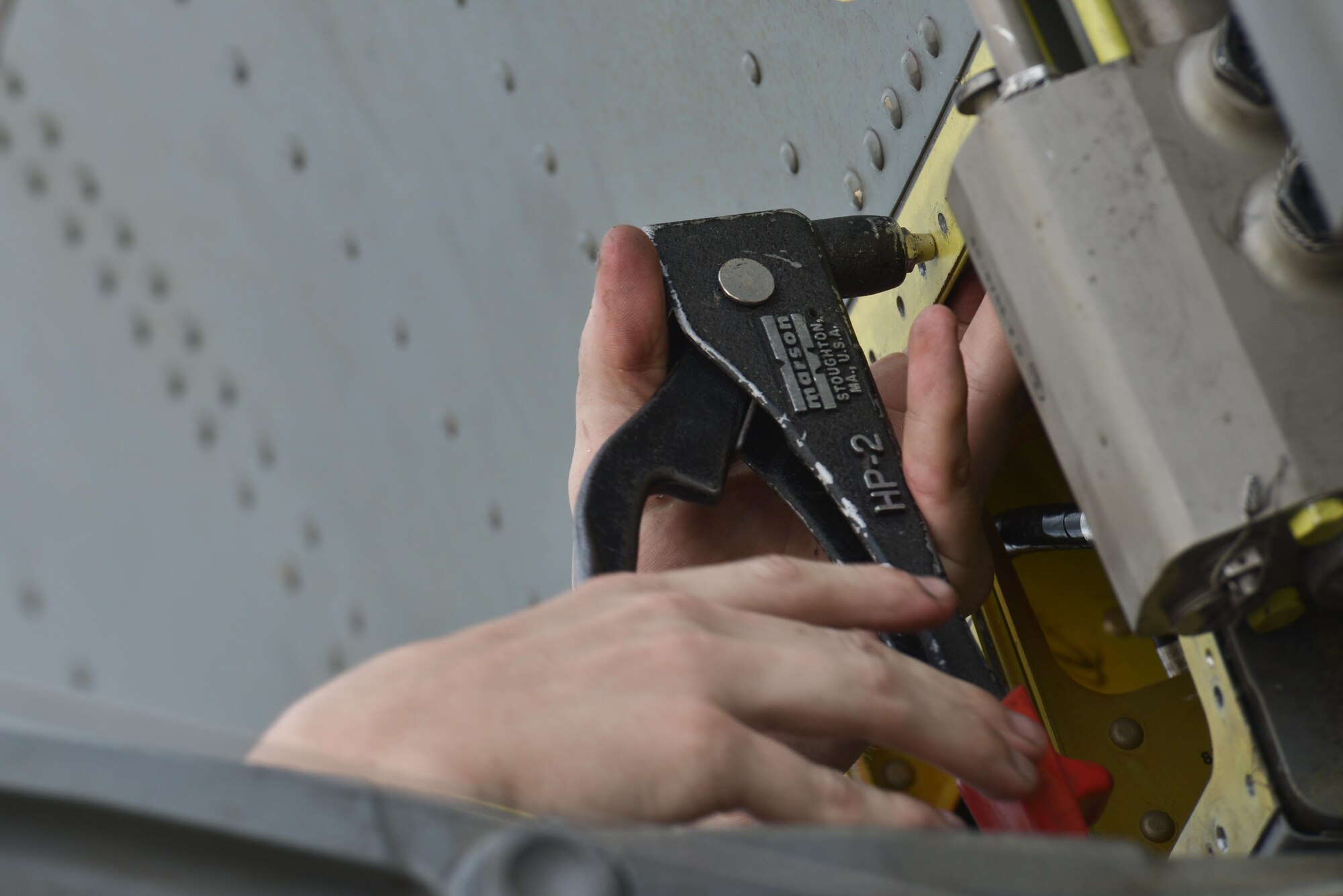 Senior Airman Adam Bentz, 379th Expeditionary Maintenance Squadron's fabrication flight, inserts new rivets to a fabricated KC-135 Stratotanker spoiler access panel August 4, 2015 at Al Udeid Air Base, Qatar. The fabrications flight is partitioned into the aircraft structural maintenance and metal technology sections that make on-site repairs to aircraft deployed to Al Udeid. Most fabrications can be conducted on the flight line. For others, Airmen would bring in the part or create what is needed to keep the aircraft flying within hours. (U.S. Air Force photo/ Staff Sgt. Alexandre Montes)