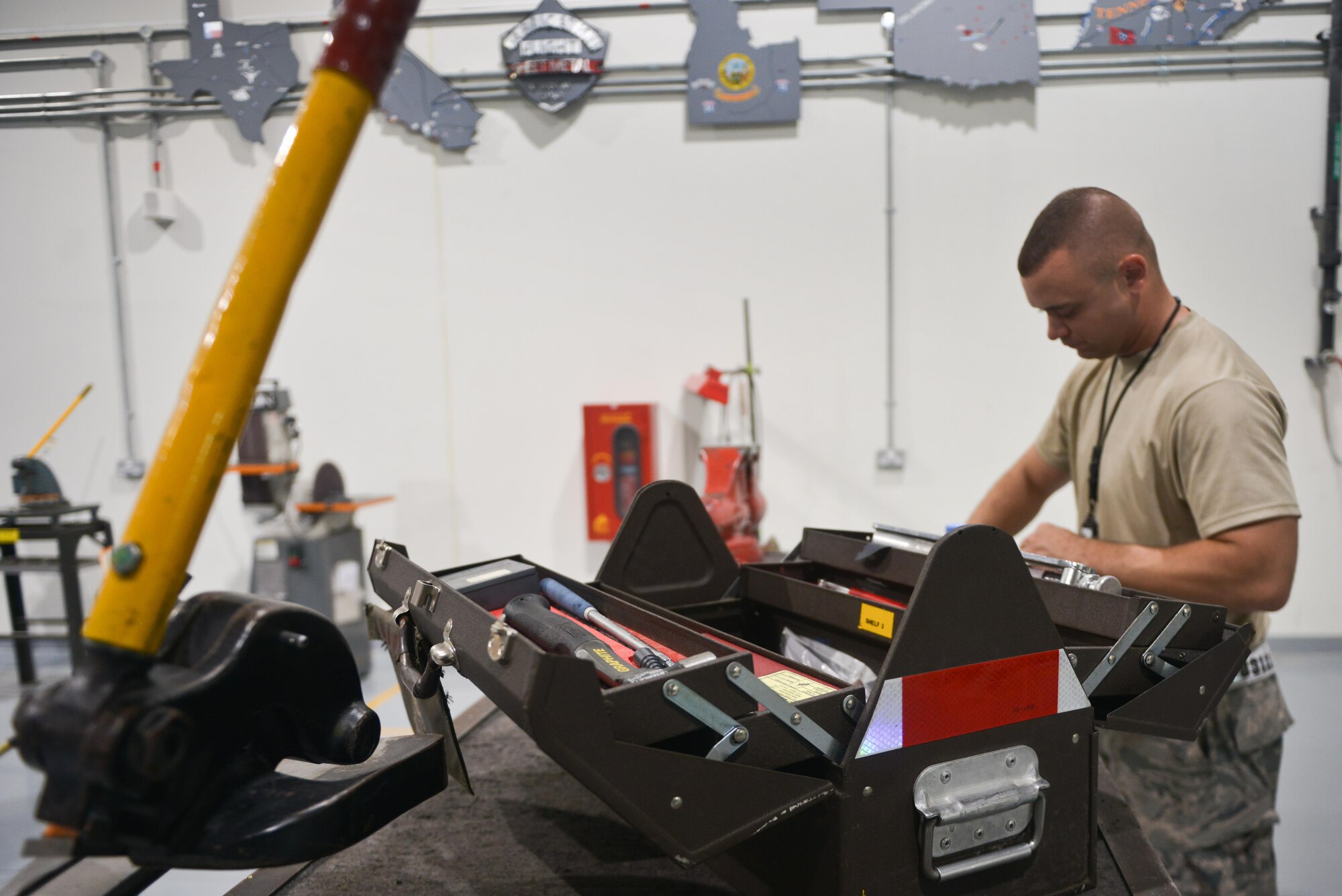 Staff Sgt. David Clark, 379th Expeditionary Maintenance Squadron's fabrication flight, prepares his tool for an on-site aircraft parts fabrication on the flight line August 4, 2015 at Al Udeid Air Base, Qatar. The fabrications flight is partitioned into the aircraft structural maintenance and metal technology sections that make on-site repairs to aircraft deployed to Al Udeid. Most fabrications can be conducted on the flight line. For others, Airmen would bring in the part or create what is needed to keep the aircraft flying within hours. (U.S. Air Force photo/ Staff Sgt. Alexandre Montes)