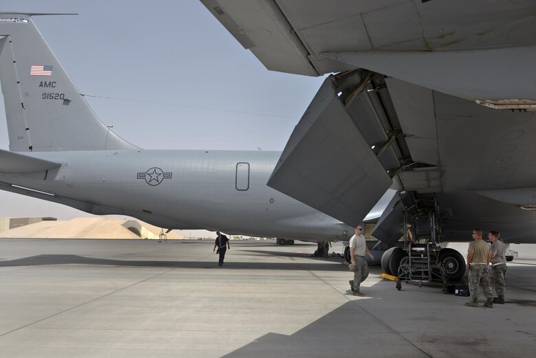 Members from the 340th Expeditionary Aircraft Maintenance Unit update Senior Airman Adam Bentz and Staff Sgt. David Clark, 379th Expeditionary Maintenance Squadron's fabrication flight, on the specific location and parts needing repairs for a KC-135 Stratotanker August 4, 2015 at Al Udeid Air Base, Qatar. The fabrications flight is partitioned into the aircraft structural maintenance and metal technology sections that make on-site repairs to aircraft deployed to Al Udeid. Most fabrications can be conducted on the flight line. For others, Airmen would bring in the part or create what is needed to keep the aircraft flying within hours. (U.S. Air Force photo/ Staff Sgt. Alexandre Montes)