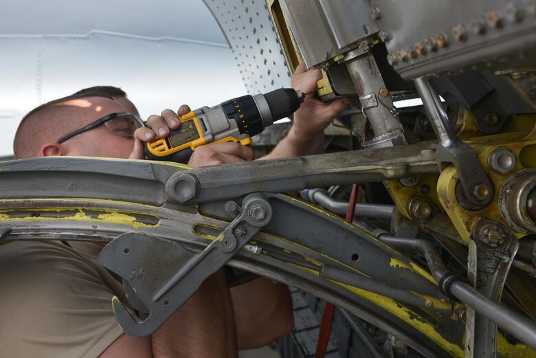 Staff Sgt. David Clark, 379th Expeditionary Maintenance Squadron's fabrication flight, drills new holes in a KC-135 Stratotanker access panel to apply new rivets August 4, 2015 at Al Udeid Air Base, Qatar. The fabrications flight is partitioned into the aircraft structural maintenance and metal technology sections that make on-site repairs to aircraft deployed to Al Udeid. Most fabrications can be conducted on the flight line. For others, Airmen would bring in the part or create what is needed to keep the aircraft flying within hours. (U.S. Air Force photo/ Staff Sgt. Alexandre Montes)