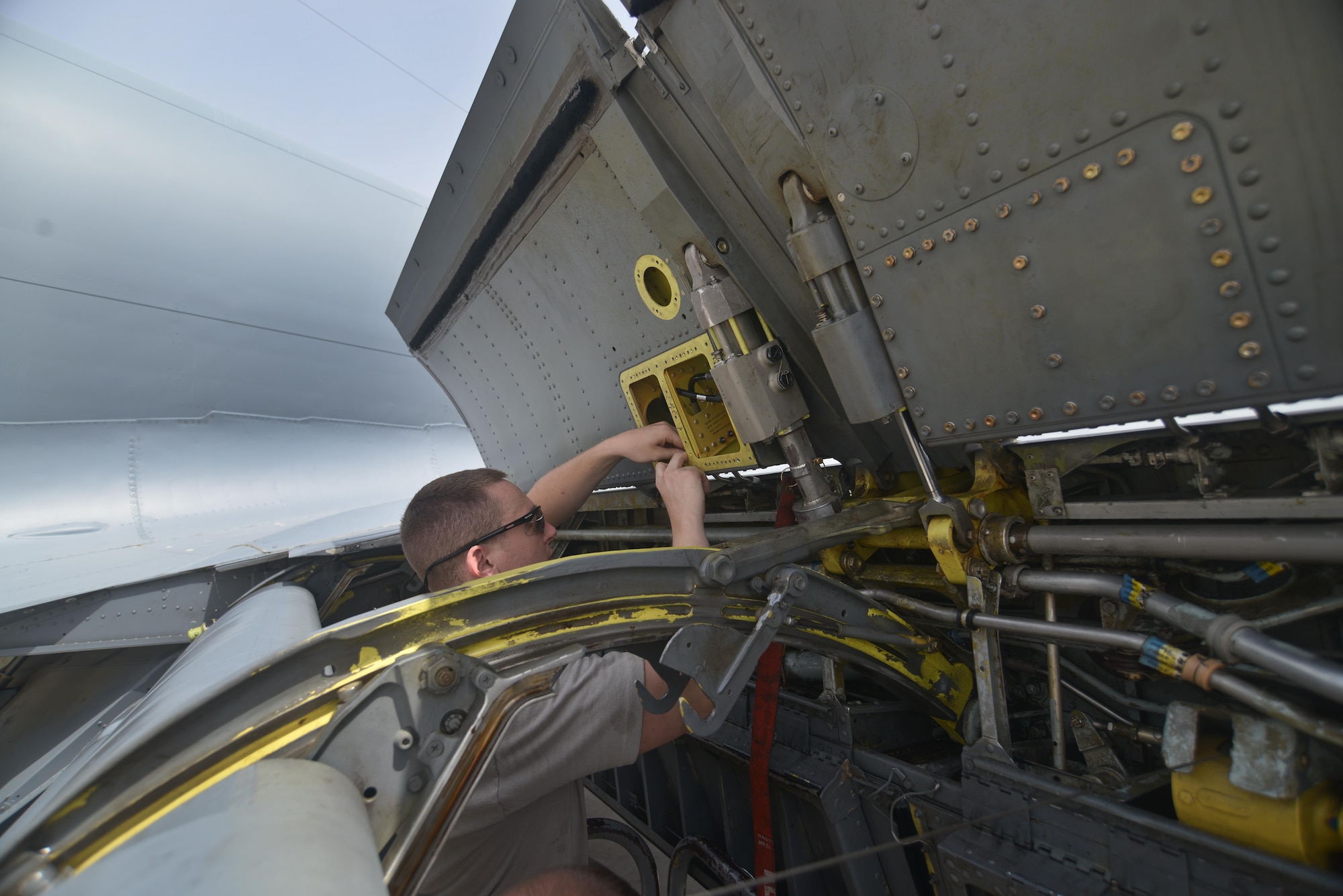 Senior Airman Adam Bentz, 379th Expeditionary Maintenance Squadron's fabrication flight, lines up a fabricated KC-135 Stratotanker spoiler access panel part for new rivets August 4, 2015 at Al Udeid Air Base, Qatar. The fabrications flight is partitioned into the aircraft structural maintenance and metal technology sections that make on-site repairs to aircraft deployed to Al Udeid. Most fabrications can be conducted on the flight line. For others, Airmen would bring in the part or create what is needed to keep the aircraft flying within hours. (U.S. Air Force photo/ Staff Sgt. Alexandre Montes)