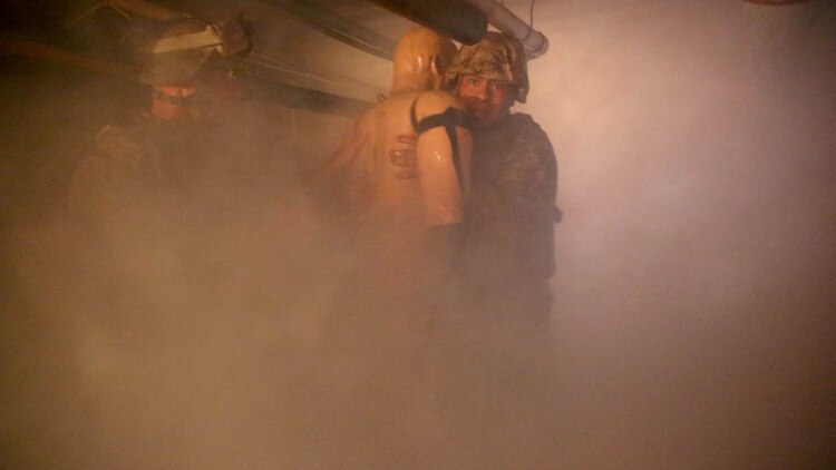 U.S. Navy corpsmen and Marines, assigned to various units in the 1st Marine Division, conduct tactical combat casualty care training during the Combat Trauma Management Course, taught by instructors with the 1st Mar. Div. Navy Education and Training Office, at the Strategic Operations facility, San Diego, July 30, 2015. The course, held once a month for 40 students, combines simulated injuries on role players and chaotic battlefield environments to prepare corpsmen and Marine combat life savers for the stress of saving lives in real world operations. 