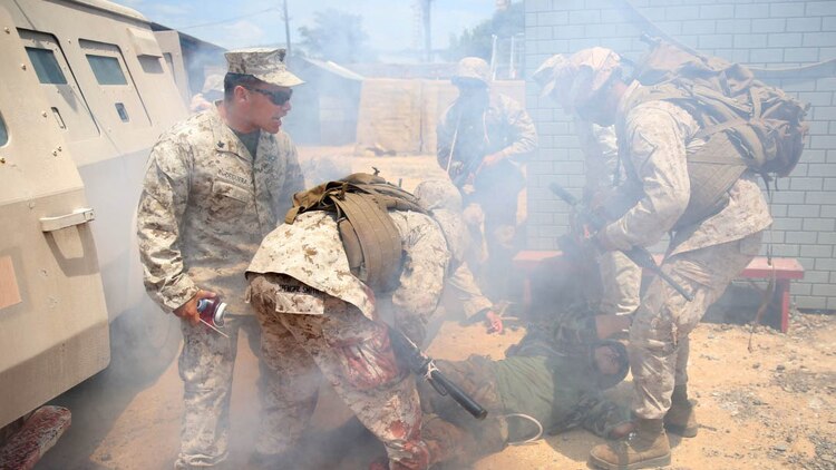 U.S. Navy corpsmen and Marines, assigned to various units in the 1st Marine Division, conduct tactical combat casualty care training during the Combat Trauma Management Course, taught by instructors with the 1st Mar. Div. Navy Education and Training Office, at the Strategic Operations facility, San Diego, July 30, 2015. The course, held once a month for 40 students, combines simulated injuries on role players and chaotic battlefield environments to prepare corpsmen and Marine combat life savers for the stress of saving lives in real world operations.   