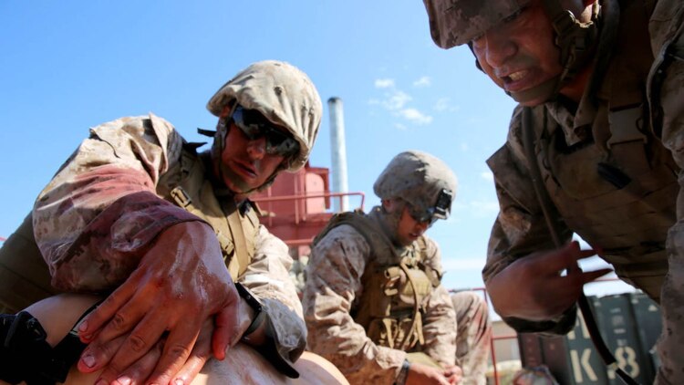 U.S. Navy corpsmen and Marines, assigned to various units in the 1st Marine Division, conduct tactical combat casualty care training during the Combat Trauma Management Course, taught by instructors with the 1st Mar. Div. Navy Education and Training Office, at the Strategic Operations facility, San Diego, July 30, 2015. The course, held once a month for 40 students, combines simulated injuries on role players and chaotic battlefield environments to prepare corpsmen and Marine combat life savers for the stress of saving lives in real world operations.   