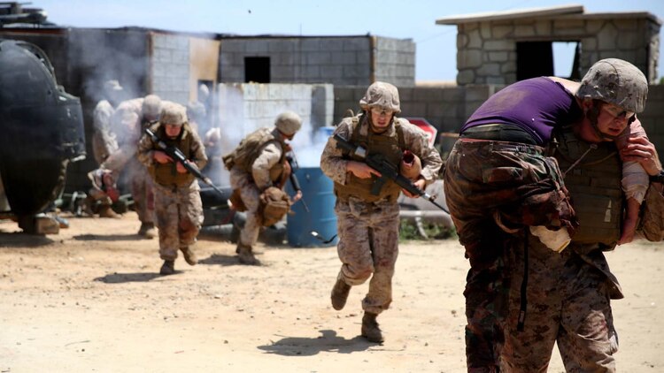 U.S. Navy corpsmen and Marines, assigned to various units in the 1st Marine Division, conduct tactical combat casualty care training during the Combat Trauma Management Course, taught by instructors with the 1st Mar. Div. Navy Education and Training Office, at the Strategic Operations facility, San Diego, July 30, 2015. The course, held once a month for 40 students, combines simulated injuries on role players and chaotic battlefield environments to prepare corpsmen and Marine combat life savers for the stress of saving lives in real world operations.   