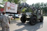 Virginia National Guard Soldiers in Sandston prepare for possible duty in response to Hurricane Irene by unloading pallets of cots and Meals Ready to Eat. The Virginia National Guard has been authorized to bring up to 300 personnel on state active duty for possible missions including high water transport and light debris removal.