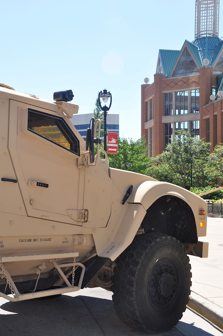 A MATV (Mine Resistant Ambush Protected All Terrain Vehicle) seemingly stands
watch over the Frontier Airlines Center in downtown Milwaukee, site of the
133rd National Guard Association of the United States General Conference and
Exhibition. Military vehicles were part of a static display alongside the Frontier Airlines Center. 