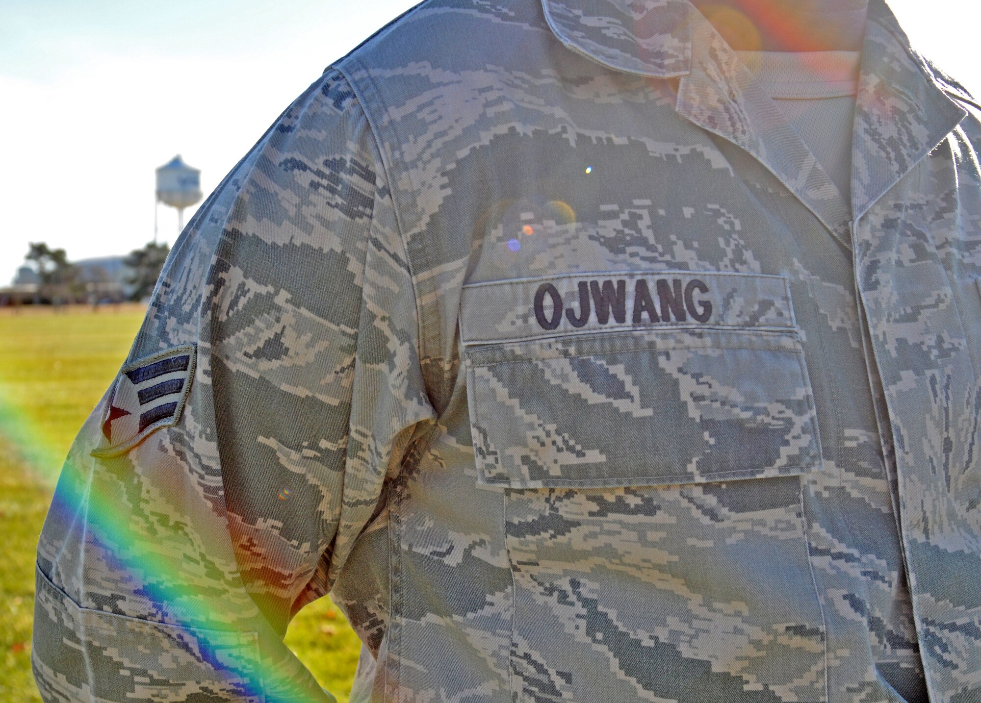 Natural light hits the lens of the camera just right to portray a rainbow light flare on the uniform of Senior Airman Maurice Ojwang's Air Force uniform. Ojwang, a financial specialist technician with the 439th Airlift Wing, Westover Air Reserve Base, Mass., is originally from Kenya, but pursued a life, essentially the 'American Dream,' in the United States after turning 18 years old. (U.S. Air Force photo by SrA. Monica Ricci/Released)