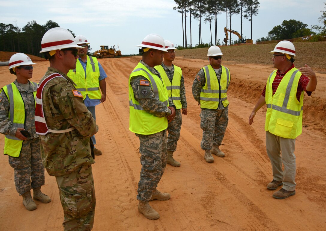 Wilmington District Project Manager Nat Hermann of the U.S. Army Special Operations Command Resident Engineer Office at Fort Bragg, right, explains the layout of a construction project to Soldiers of the 133rd Construction Management Team also of Fort Bragg. From left; Staff Sgt. Erin Hogue, 1st Lt. Nathan Sponsel, Quality Assurance Representative Deven Dalcher, Spec. Erick Valentin, Capt. Joe Cho, and Sgt. First Class George Angel. 