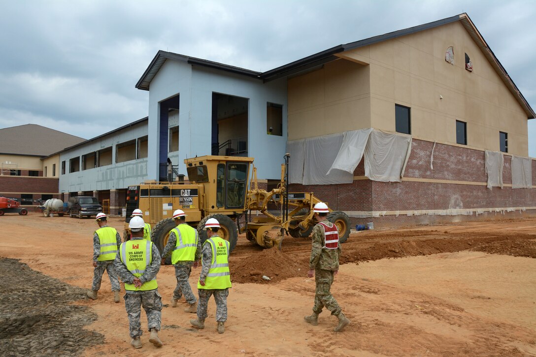 Soldiers from the 133rd Construction Management team at Fort Bragg observe the foundation layout of a building under construction that will accommodate Soldiers of the 95th Civil Affairs Brigade. (USACE photo by Hank Heusinkveld) 

