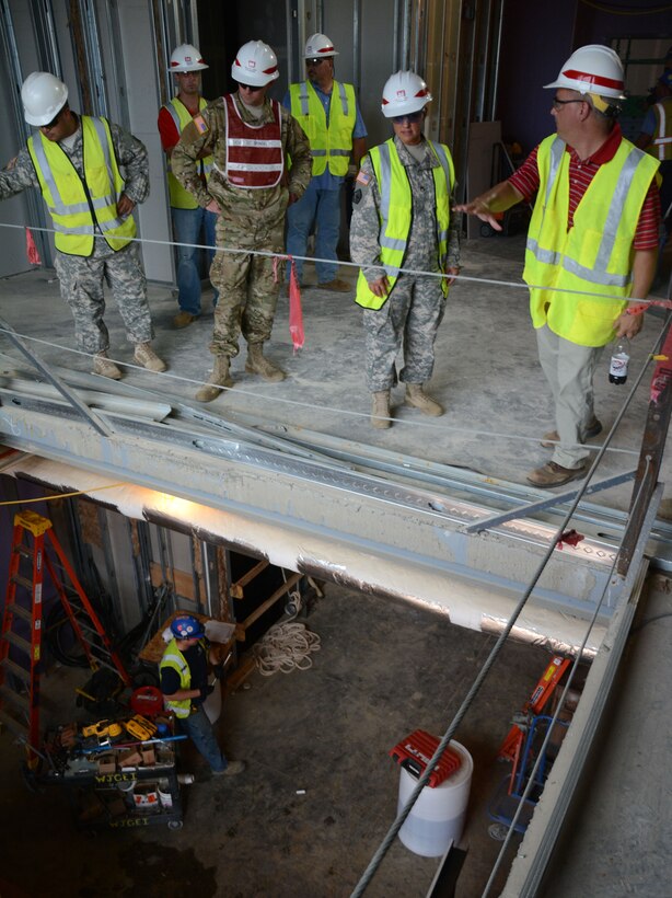 Wilmington District Project Manager Nat Hermann of the U.S. Army Special Operations Command Resident Engineer Office at Fort Bragg, right, explains the layout of a 95th Civil Affairs Brigade construction project to Soldiers of the 133rd Construction Management Team also of Fort Bragg. From left; Sgt. First Class George Angel, Construction Control Representative Thomas Avera (USACE), 1st Lt. Nathan Sponsel, Civil Engineer Deven Dalcher (USACE) and Staff Sgt. Erin Hogue.


