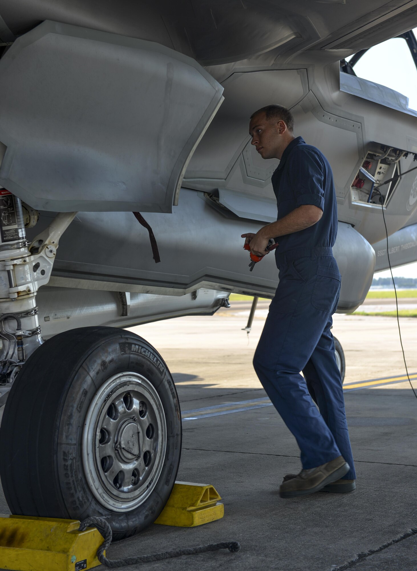 Airman 1st Class Zachary Weeks, 33rd Aircraft Maintenance Squadron crew chief, removes pins from an F-35A Lighting II before launch at Eglin Air Force Base, Fla., August 4, 2015. Week’s responsibility on the flight line is to safely inspect and launch the F-35A Lighting II. (U.S. Air Force Photo/Senior Airman Andrea Posey)