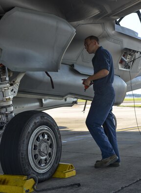 Airman 1st Class Zachary Weeks, 33rd Aircraft Maintenance Squadron crew chief, removes pins from an F-35A Lighting II before launch at Eglin Air Force Base, Fla., August 4, 2015. Week’s responsibility on the flight line is to safely inspect and launch the F-35A Lighting II. (U.S. Air Force Photo/Senior Airman Andrea Posey)