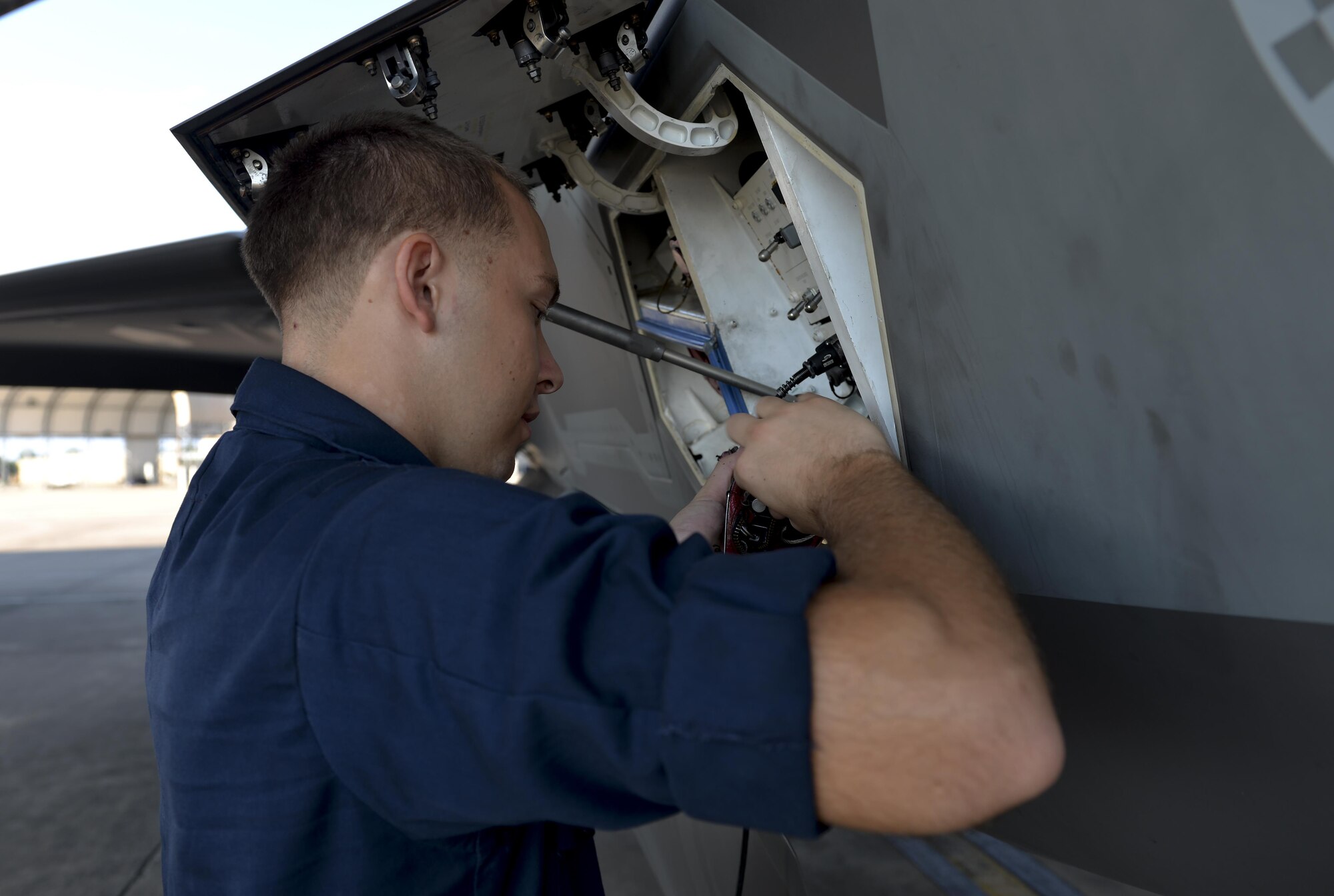 Airman 1st Class Zachary Weeks, 33rd Aircraft Maintenance Squadron crew chief, stores pins from an F-35A Lighting II before launch at Eglin Air Force Base, Fla., August 4, 2015. Week’s responsibility on the flight line is to safely inspect and launch the F-35A Lighting II. (U.S. Air Force Photo/Senior Airman Andrea Posey)