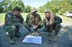 Capt. Teng Yang, Maj. Vince Repucci and Lt. Col. Perry Sorg (left to right), all aircrew members with the 757th Airlift Squadron, use GPS coordinates and a map to plot their route through the woods during a combat survival skills training course here, July 31, 2015. Approximately ten aircrew members were at Camp Ravenna Joint Military Training Center for an aircrew combat survival skills training course. The course is a triennial requirement for aircrew members and provides skills for surviving, evading capture, resisting the enemy and escaping a hostile environment. (U.S. Air Force photo/Eric M. White