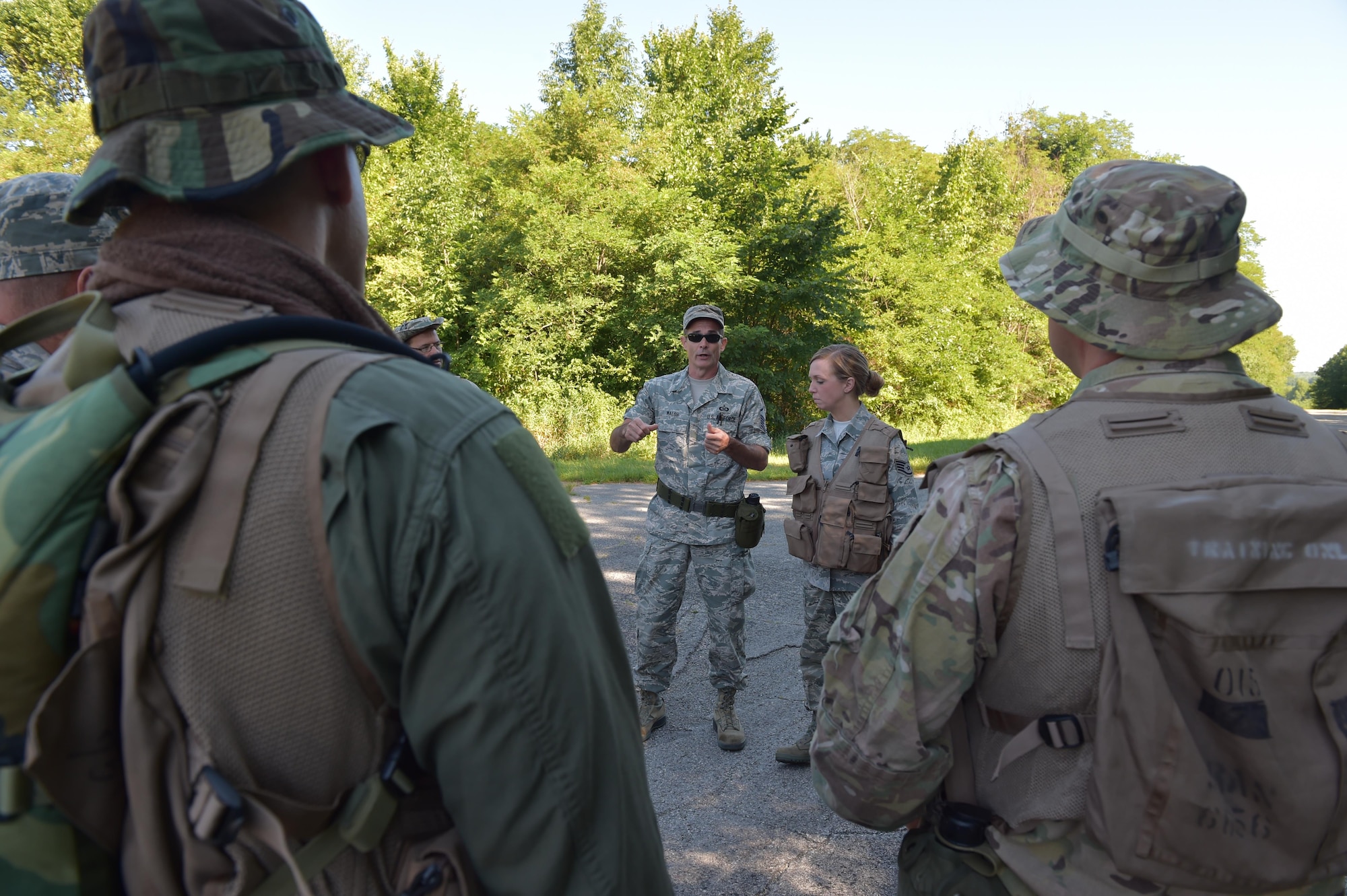 Master Sgt. Phillip Walsh, aircrew flight equipment craftsman with the 910th aircrew flight equipment maintenance shop, instructs 910th Operations Group aircrew members on the various items in their survival vests here, July 31, 2015. Approximately ten aircrew members were at Camp Ravenna Joint Military Training Center for an aircrew combat survival skills training course. The course is a triennial requirement for aircrew members and provides skills for surviving, evading capture, resisting the enemy and escaping a hostile environment. (U.S. Air Force photo/Eric M. White)
