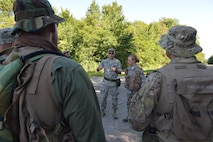 Master Sgt. Phillip Walsh, aircrew flight equipment craftsman with the 910th aircrew flight equipment maintenance shop, instructs 910th Operations Group aircrew members on the various items in their survival vests here, July 31, 2015. Approximately ten aircrew members were at Camp Ravenna Joint Military Training Center for an aircrew combat survival skills training course. The course is a triennial requirement for aircrew members and provides skills for surviving, evading capture, resisting the enemy and escaping a hostile environment. (U.S. Air Force photo/Eric M. White)