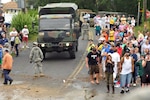 Members of the 192nd Multi-Functional Engineer Battalion, Connecticut Army
National Guard guide a vehicle through the crowd looking at flooding along
the shore in the aftermath of Hurricane/Tropical Storm Irene on Aug. 28,
2011. The engineers were among many Connecticut Guardsmen called out to
assist local authorities before, during and after the storm battered the
coastline.