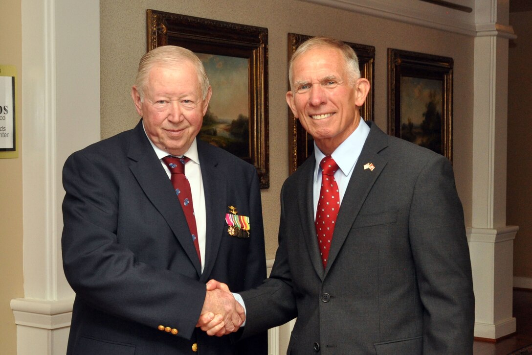 Col. William G. Swarens (Ret.) (right), shakes the hand of Lt. Gen. Henry P. Osman (Ret.) during Swarens’ retirement ceremony July 30 at the Clubs at Quantico. Swarens has overseen Marine Corps records since 1988 when, as an active-duty Marine, he managed the Marines’ records and Performance Evaluation System.